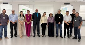 A imagem mostra onze pessoas - sete homens e quatro mulheres - posando lado a lado para a foto. ...