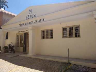 Foto retangular colorida da fachada do Fórum Ministro José Linhares. Na parte superior da estrut...