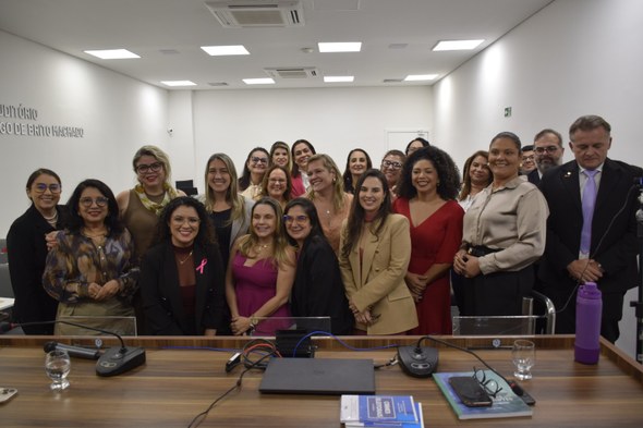 TRE-CE participa do I Encontro sobre Violência Política de Gênero, na OAB-CE A primeira imagem mostra três mulheres em pé lado a lado, posando para foto em frente a um paine...
